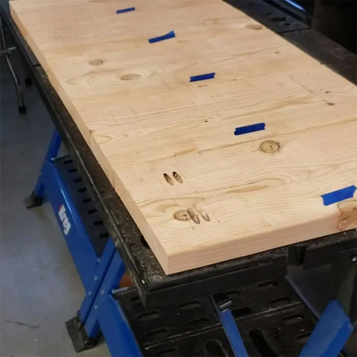 Plant Stand shelves lined up on work table with guide lines in pencil.