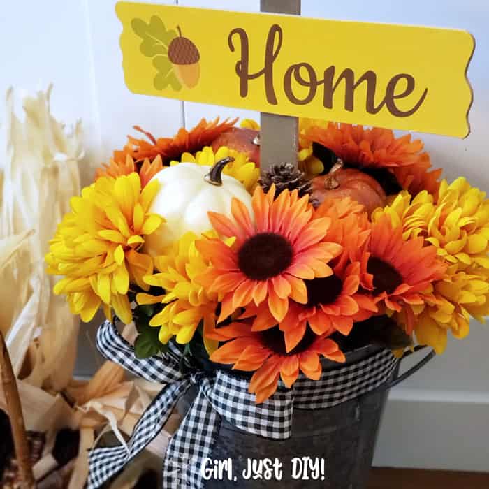 Fall flower bucket diy with gingham ribbon tied at top.