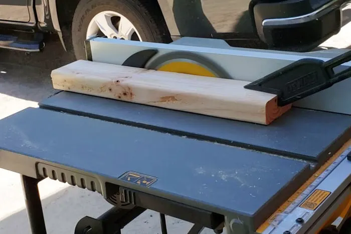 Trimming sides of 2x4 legs on table saw.