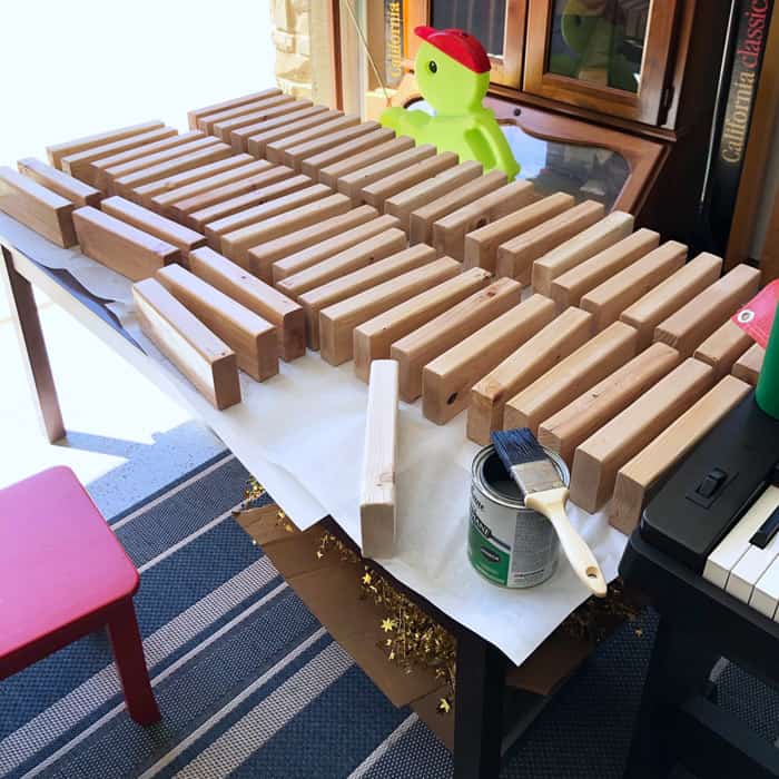 2x4s spread out on work table getting a coat of clear poly.