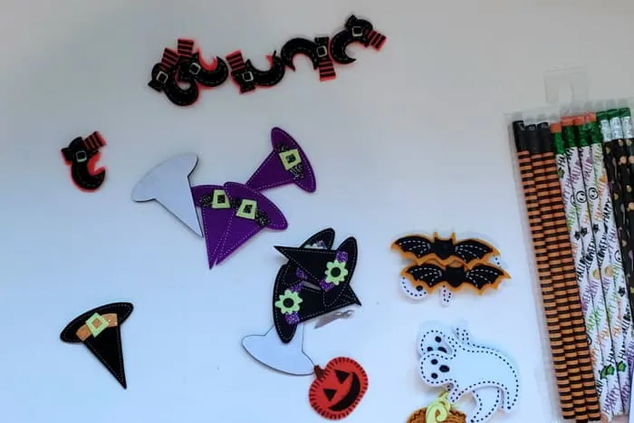 Halloween craft felt stickers on table with pencils preparing to make non-candy halloween treats.