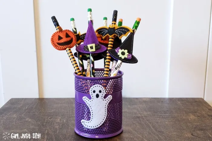 Pencil cup filled with non-candy Halloween treats for kids to give out on halloween night.