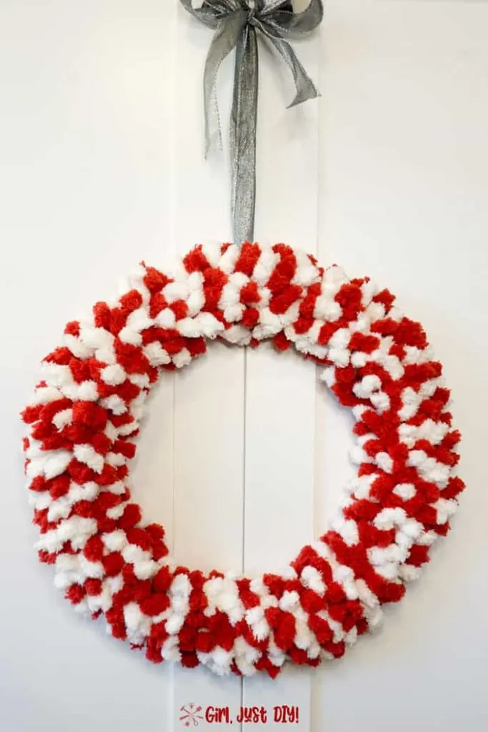 Red and white fluffy christmas wreath with silver ribbon hanger..