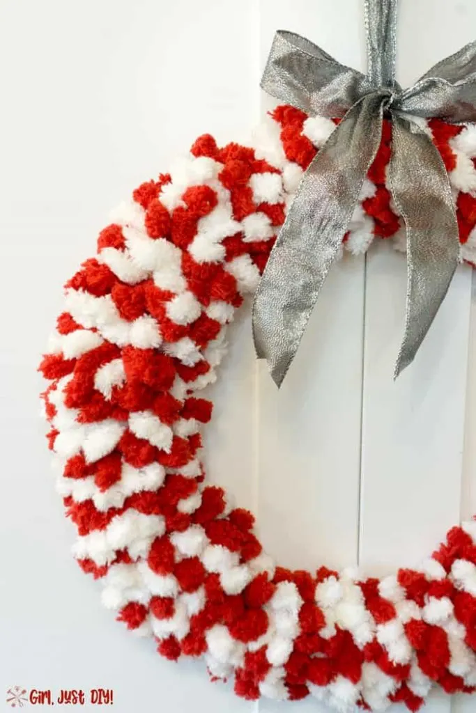 Simple but elegant Red and white fluffy christmas wreath with silver ribbon.
