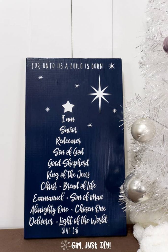 White on Blue DIY Christmas Tree Word Art Sign next to White Christmas tree with silver bulbs.