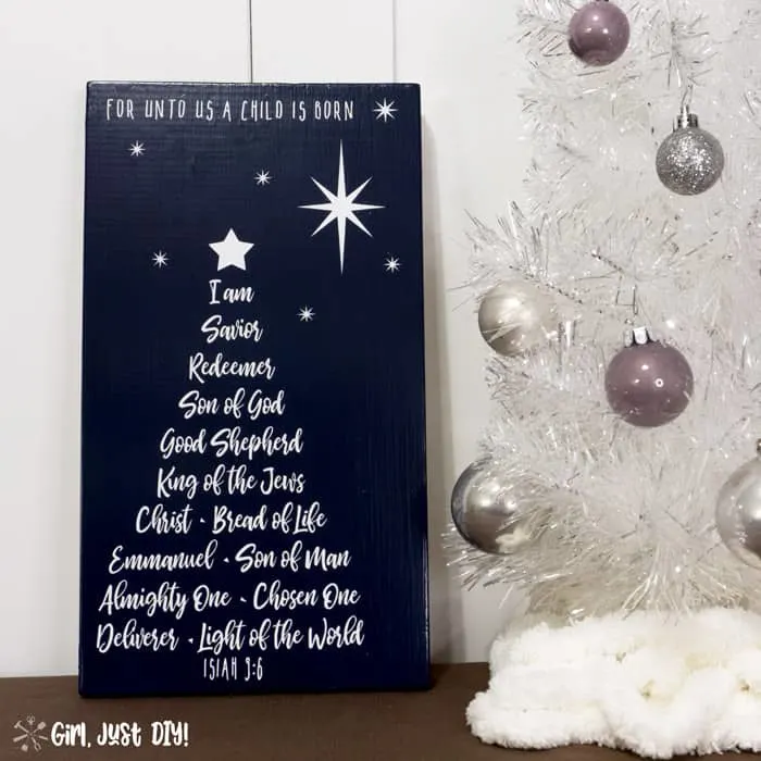 Square image of Christmas Tree Word Art Sign next to white Christmas tree with silver bulbs.