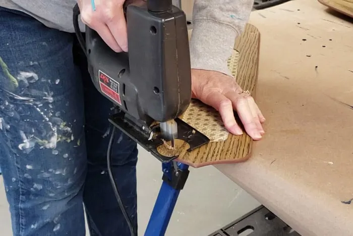 Jigsaw cutting a point on one end of an old fan blade.