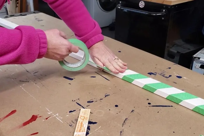 Wrapping a white 1x2 pole with green painter's tape