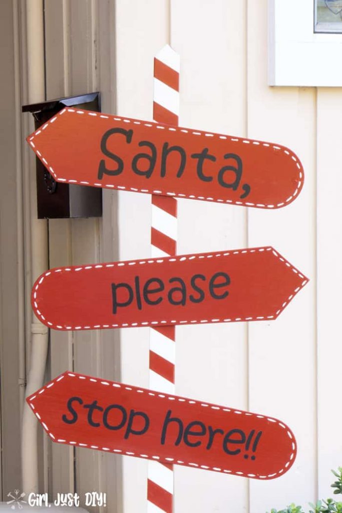 Santa stop here sign closeup showing white dashes around red fan blades.