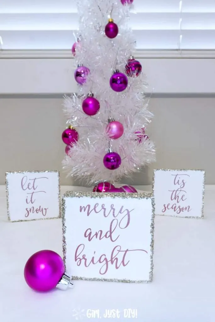 Merry and Bright Christmas Wood sign in front of two more by white Christmas tree.