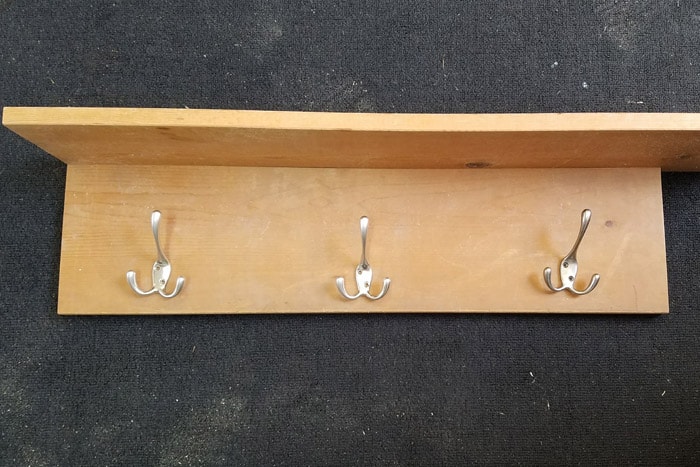 Boards on floor with silver hooks