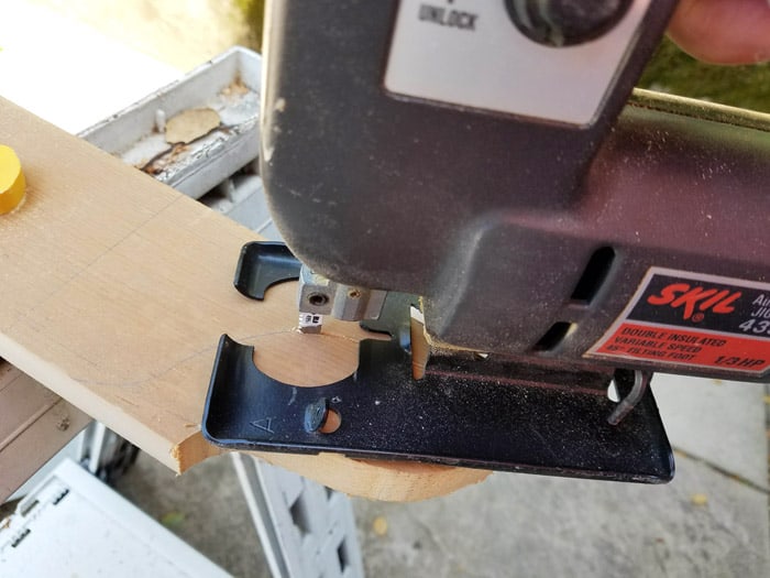 Corbels being cut from wood board with a jigsaw.