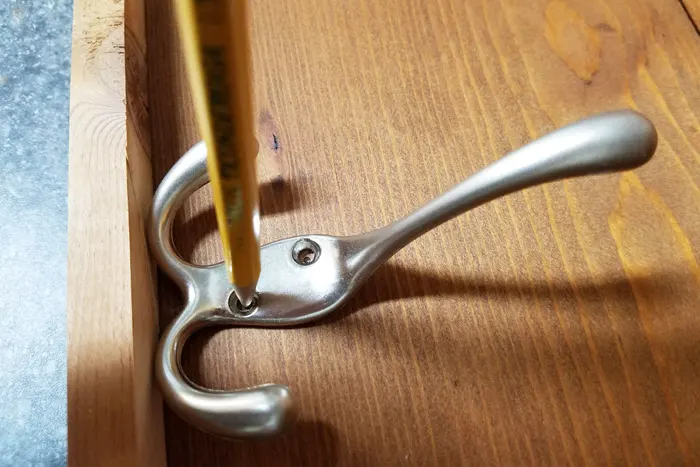 Marking the location of coat hooks with pencil