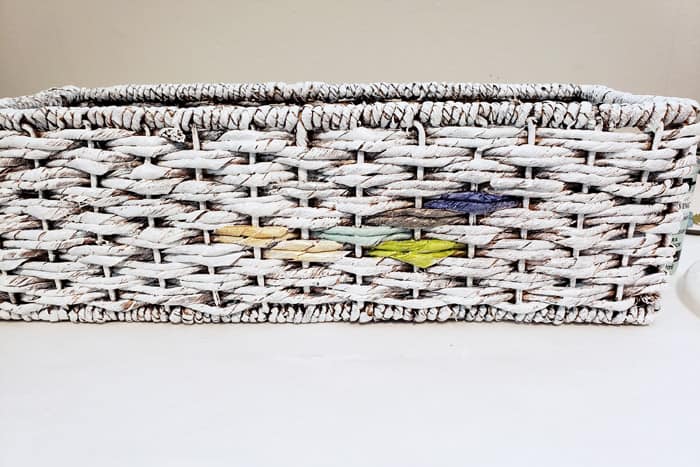 White painted basket with colorful paint swatches