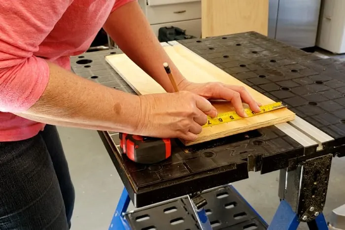 Marking lines using a tape measure and pencil