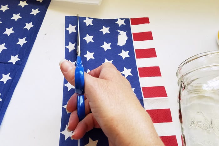 Cutting 1" section from a red white and blue napkin