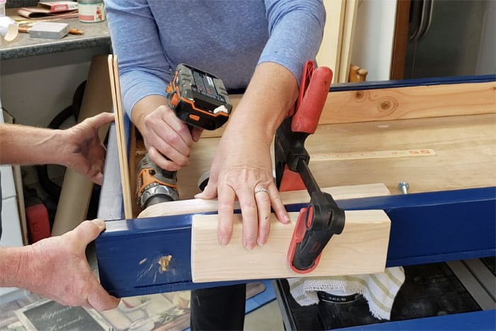 Drilling hole through side of cornhole board