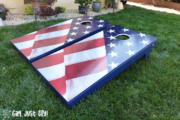 Cornhole board games on front lawn with american flag decal