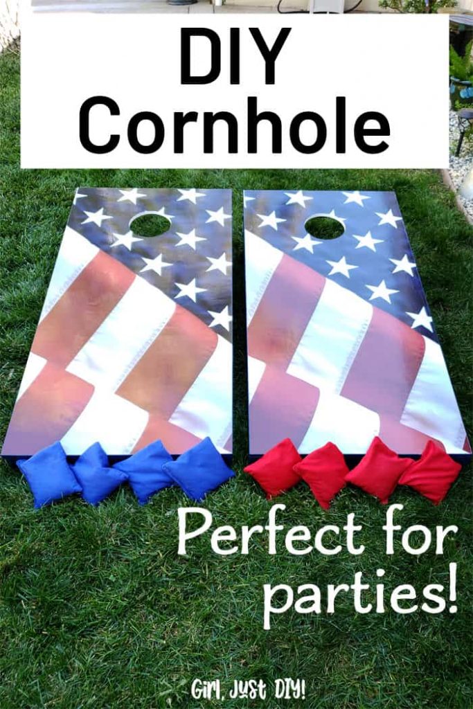 Cornhole boards on grass with game bags.