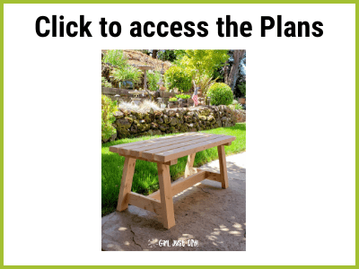 Picture of wooden bench by grass and retaining wall.