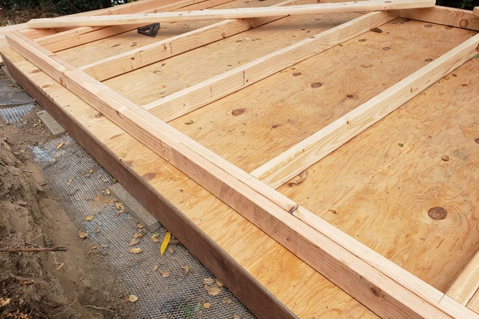 Side wall framed laying on shed decking.