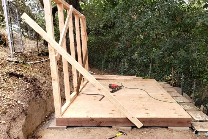 Side shed wall installed and braced on platform.