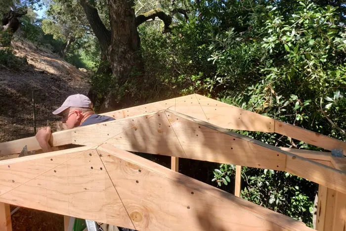 Trusses being installed using string line for center peak