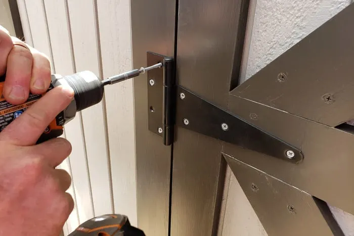 screwing shed door hinges to door frame trim