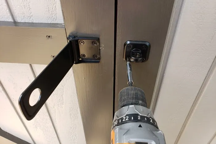 installing latch and lock to shed door with cordless drill
