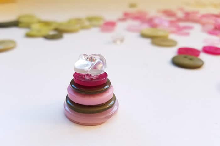 small stack of pink and green buttons to top the button Christmas tree