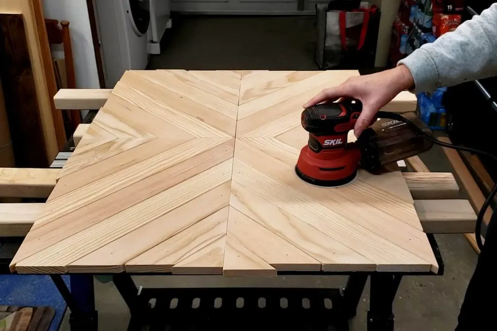 orbital sander sanding the top of the DIY coffee mug rack smooth