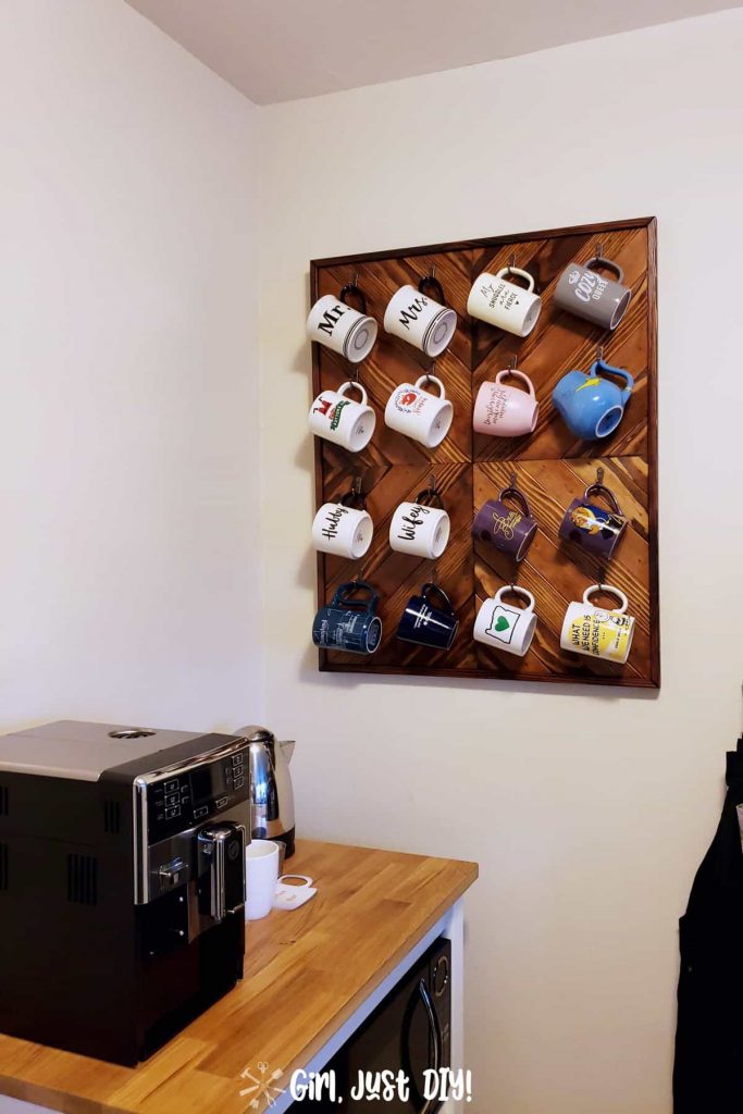 DIY Coffee Mug Rack hanging on wall in kitchen filled with coffee cups.