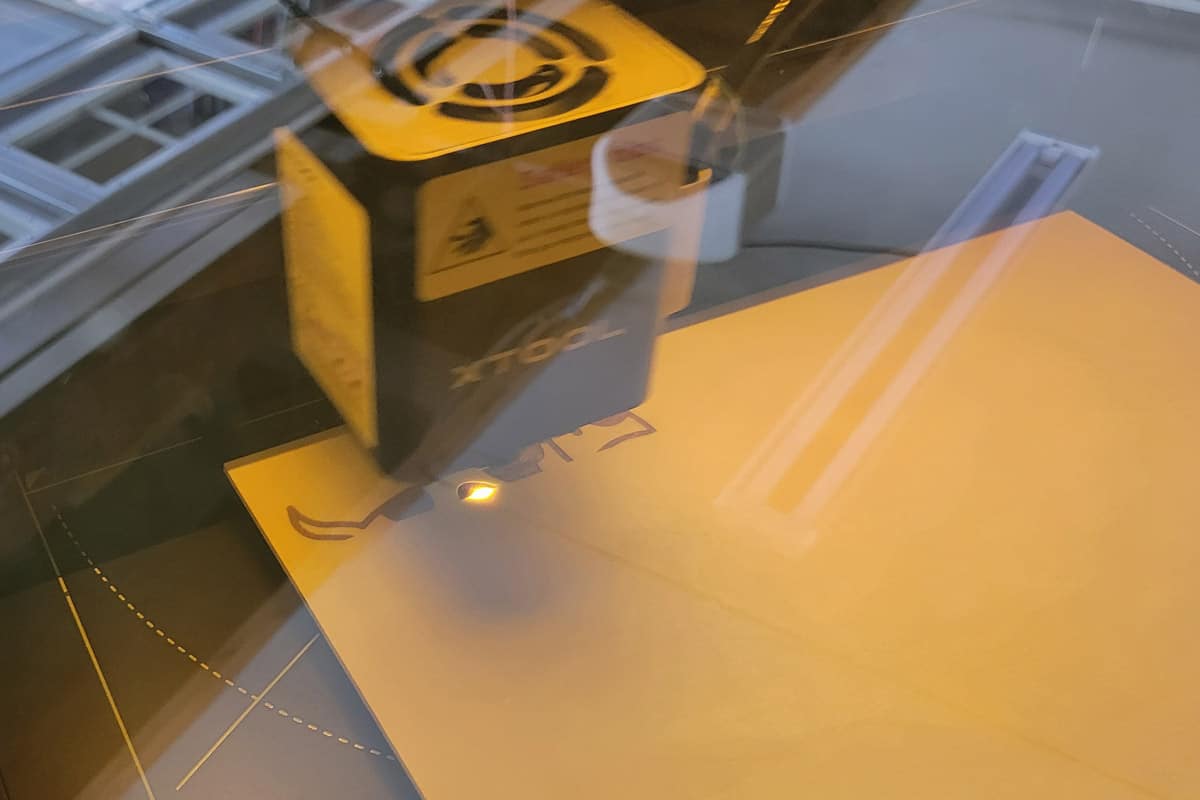 A cow image being engraved with a laser