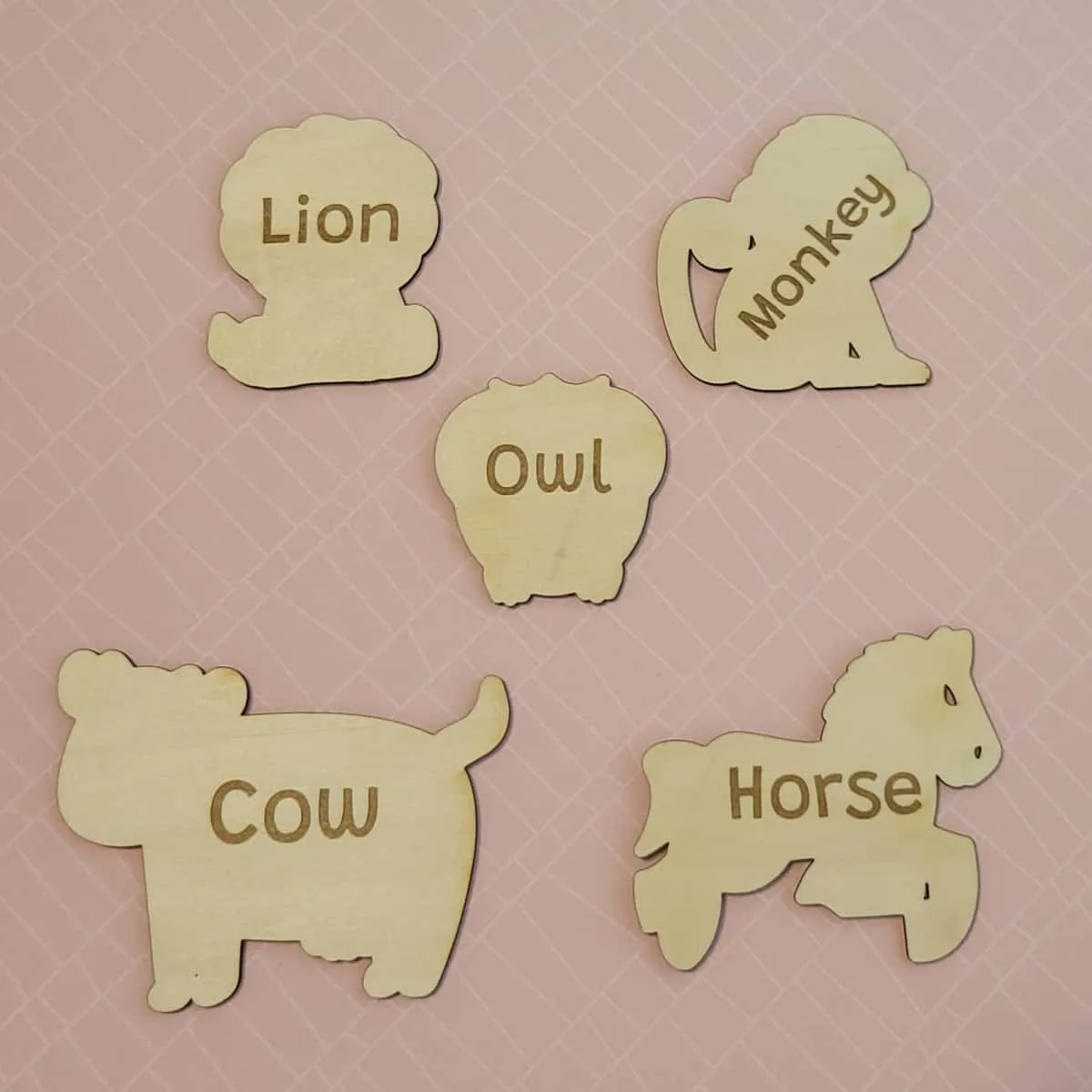 Back side of wood cutouts showing animal names