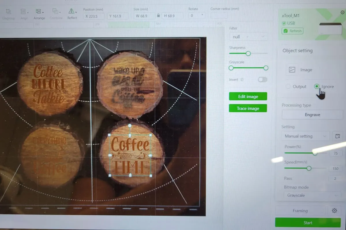 computer screen of laser engraver program and wood coasters ready to process.
