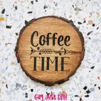 Engraved wood coaster on tabletop that reads Coffee Time