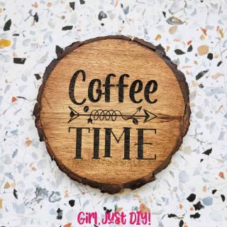Engraved wood coaster on tabletop that reads Coffee Time