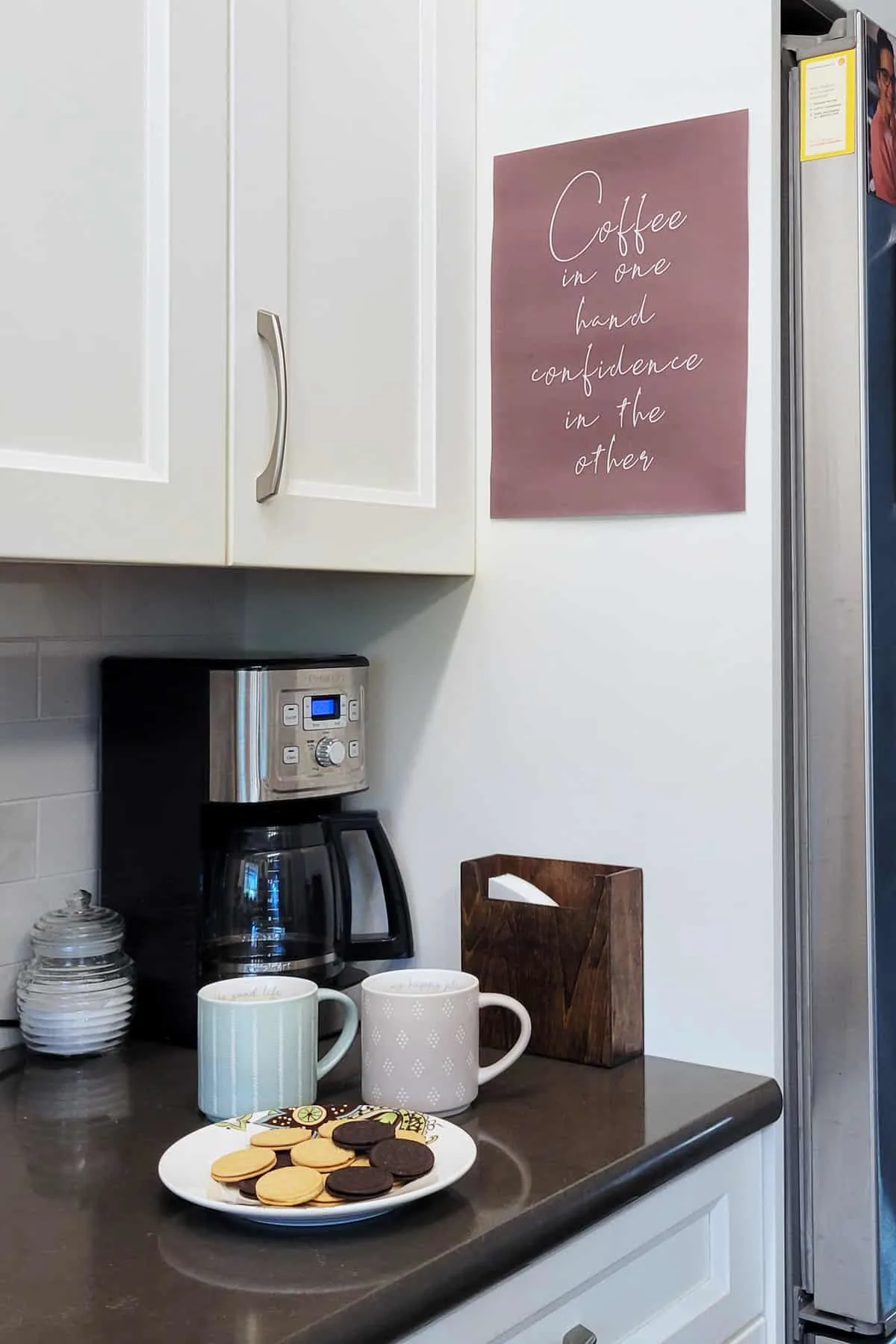 Coffee station in kitchen with a coffee poster on the wall.