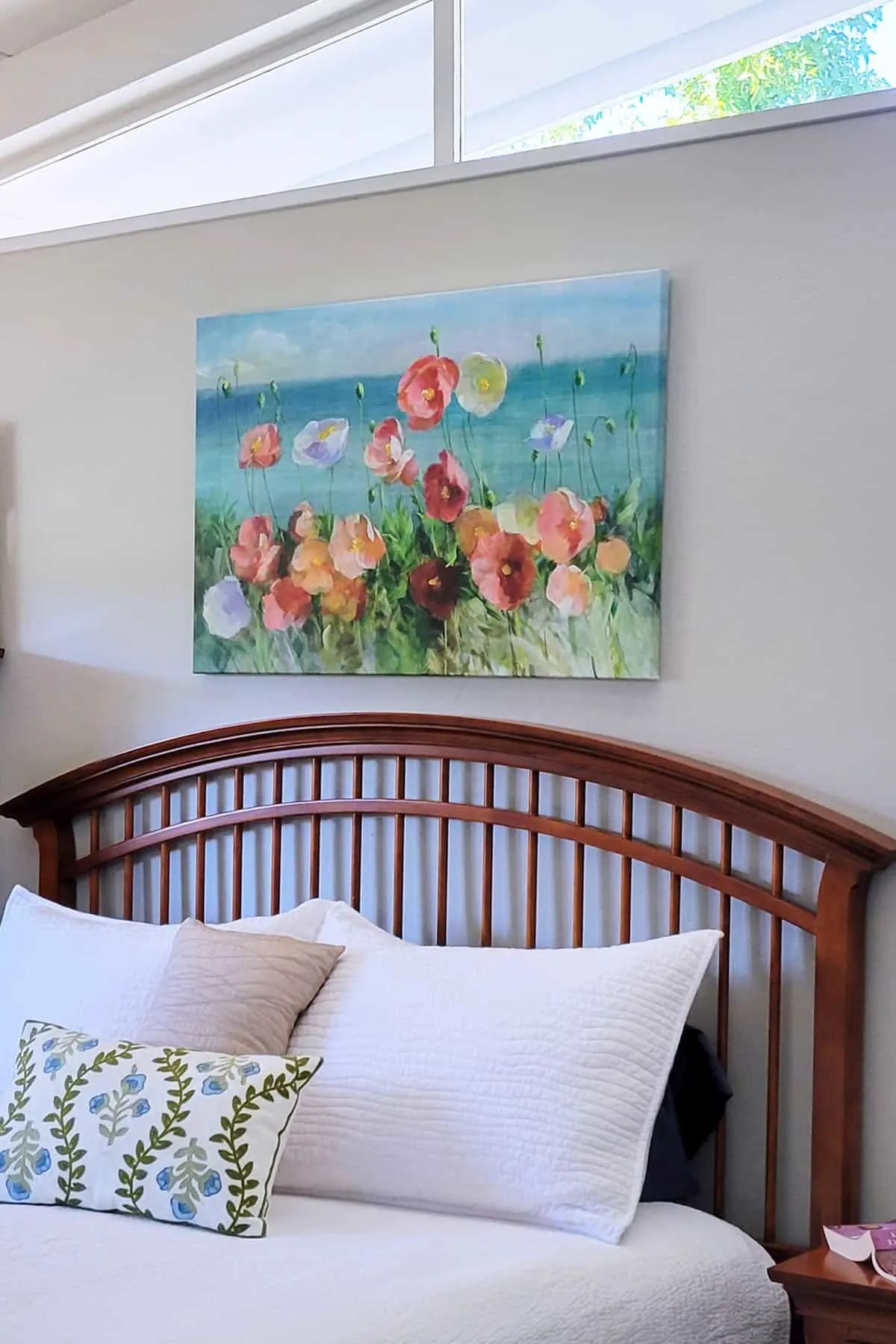 Canvas of Poppies hanging on wall above bed.