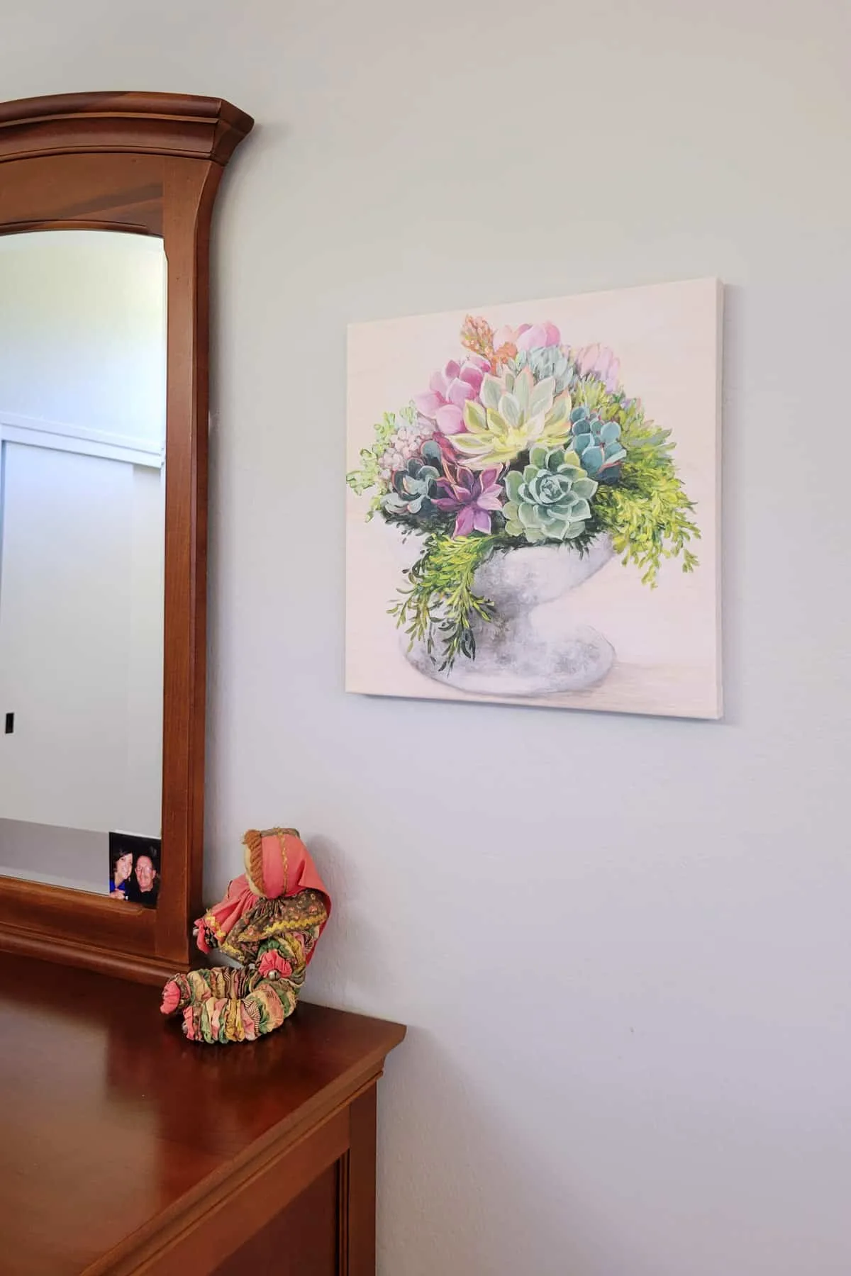 Succulent Canvas hanging on wall near mirror.