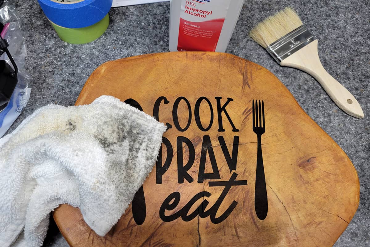 Cleaning soot off engraved cutting board with alcohol and rag