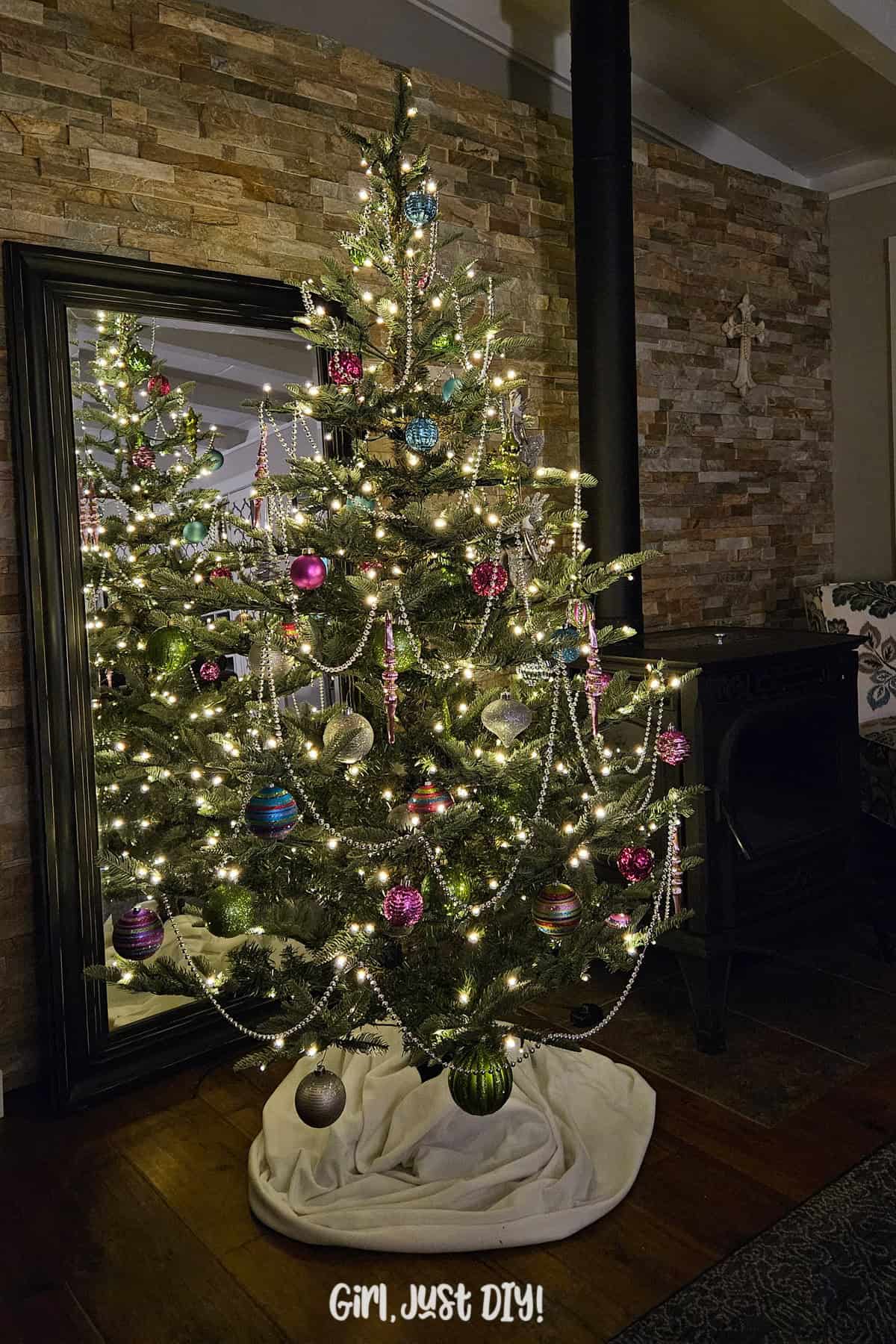 Night view of a six foot decorated christmas tree with LED lights on.